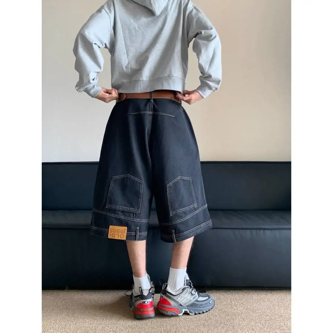 These Denim Shorts Feature A Rolled-Up Hem At The Waist, A Stylish And Versatile Design, And A Loose, Straight-Leg Fit.